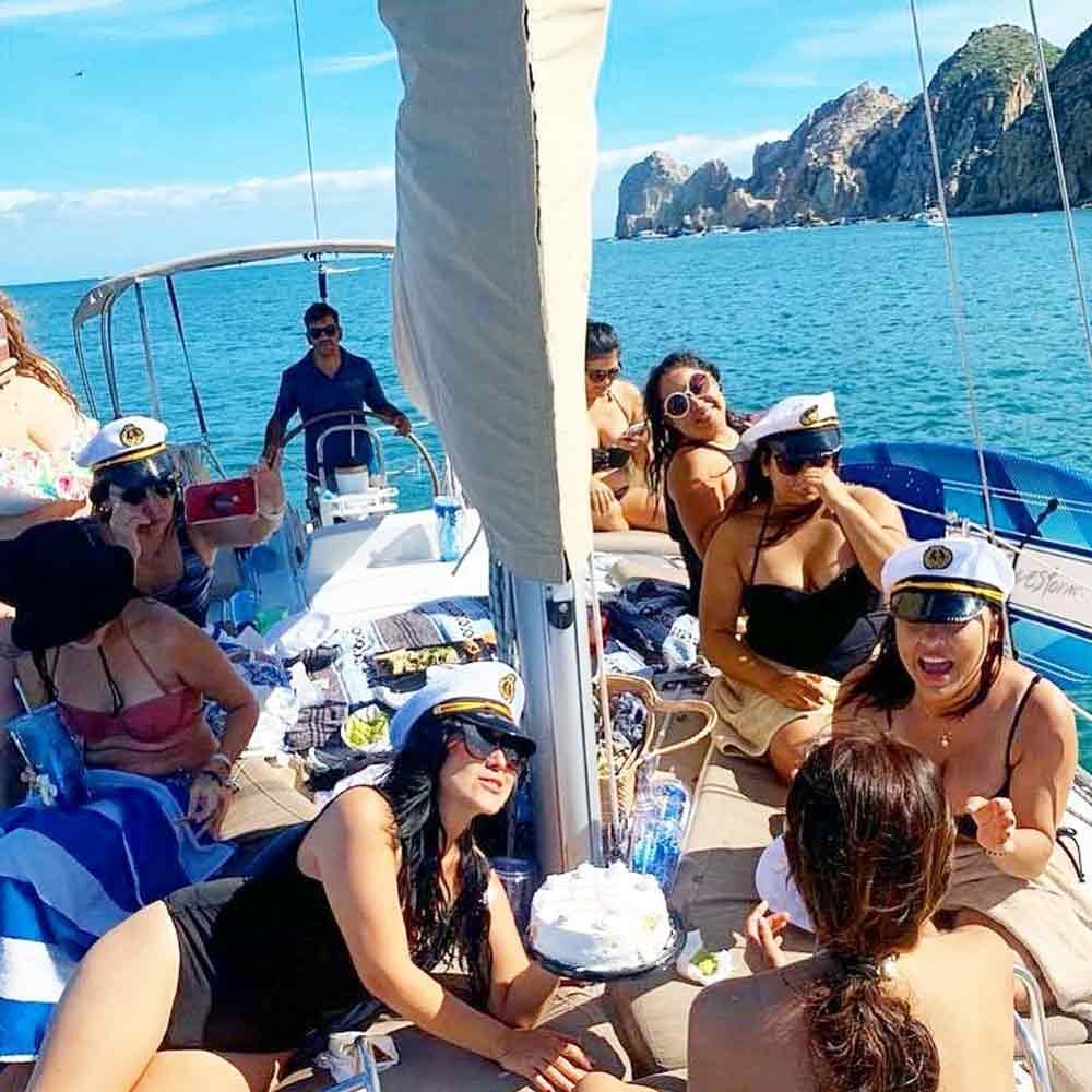 Cheers with champagne on a private bachelorette boat in Cabo.
